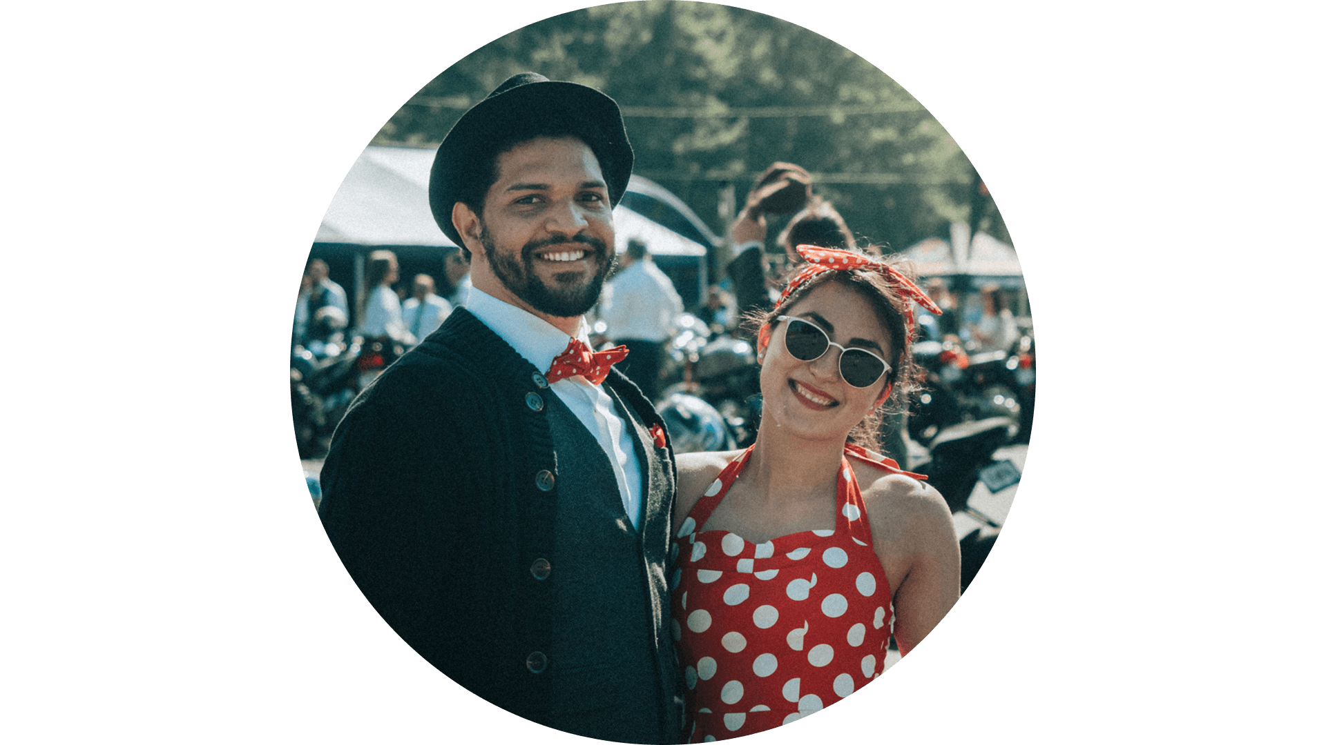A man and woman dressed in matching dapper clothing at a DGR ride event.