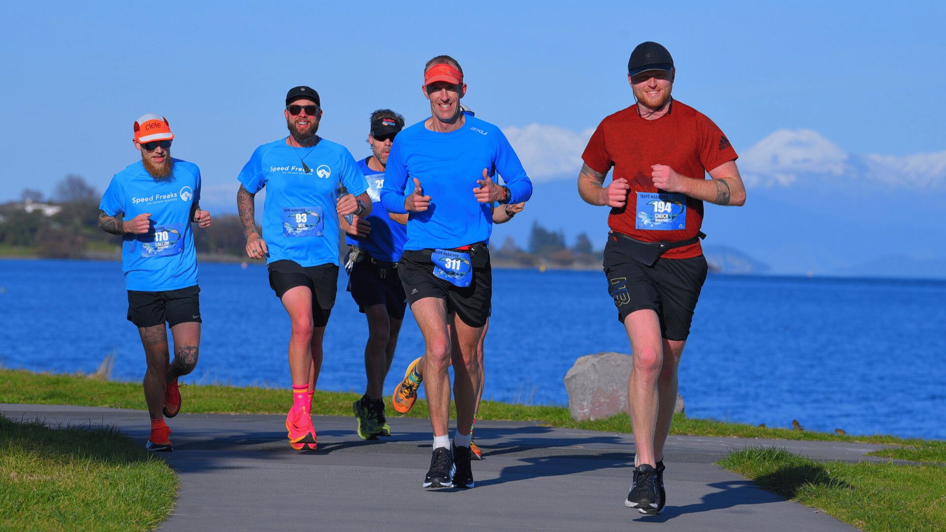 Photo of marathon runners looking to camera.