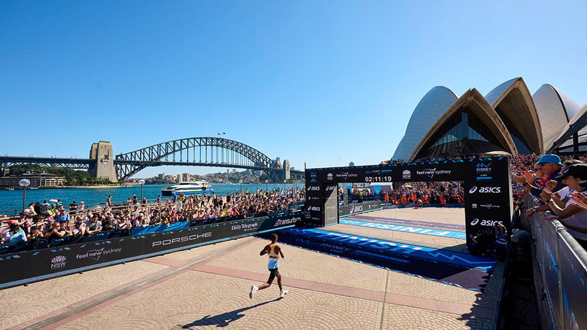 Photo of Sydney Marathon runner about to cross the finish line.