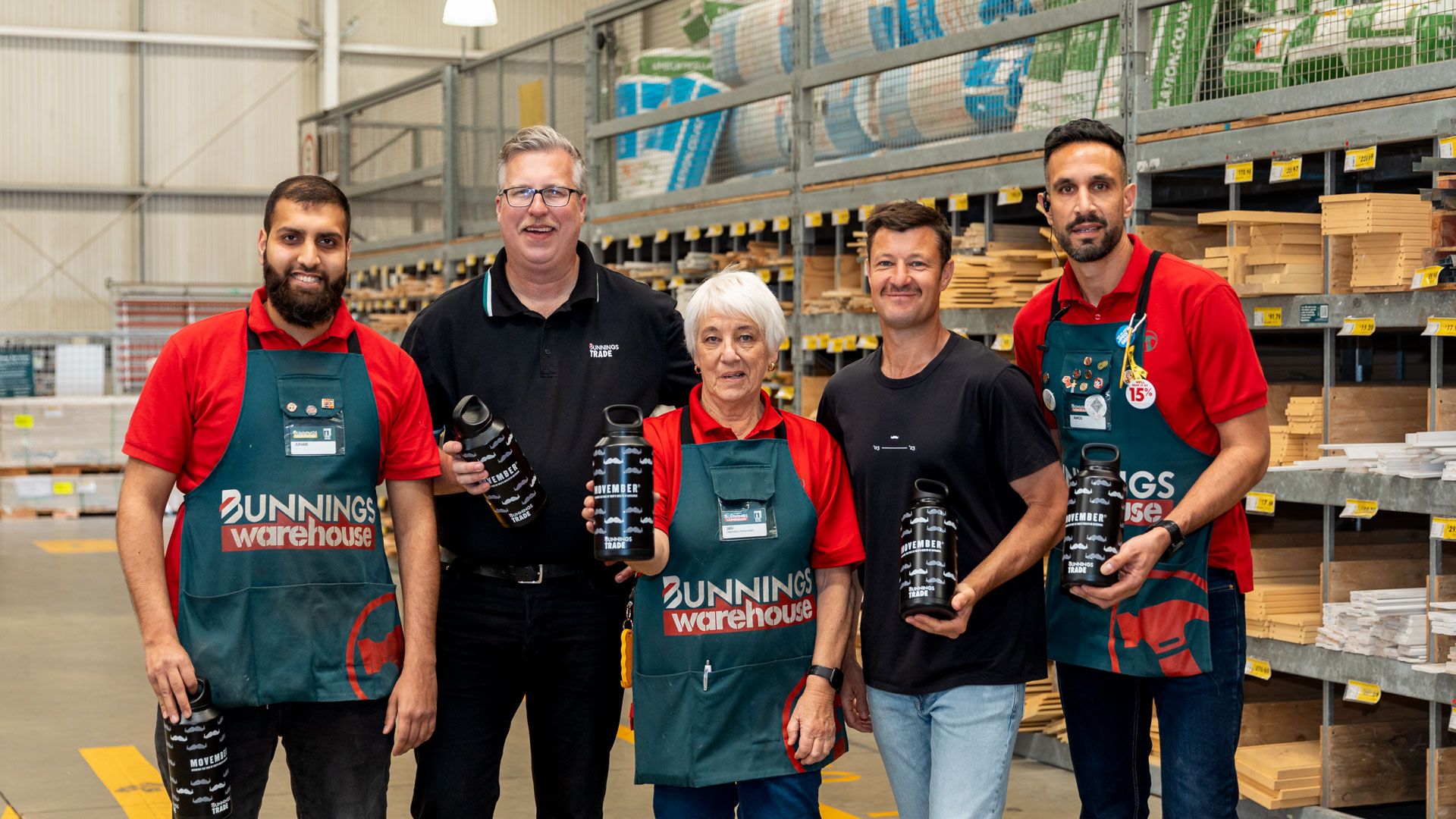 Five people hold drink bottles in Bunnings store