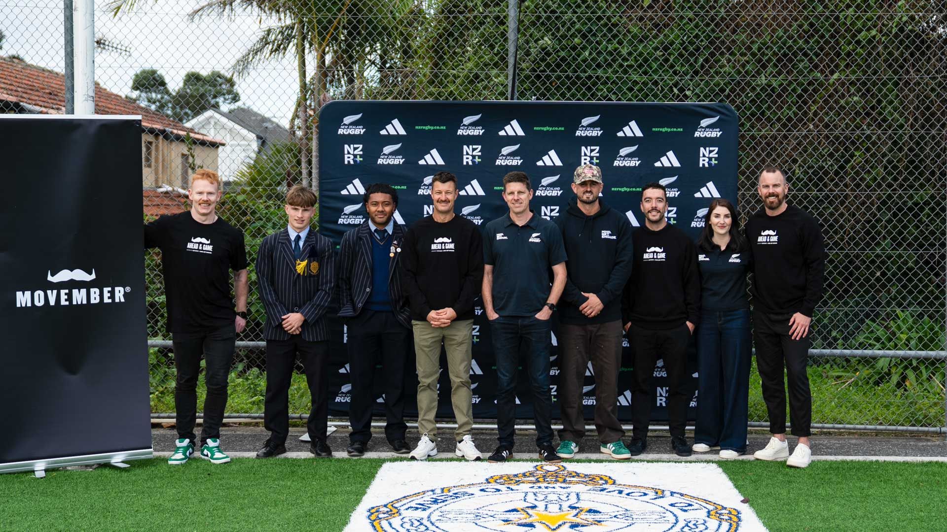 Photo of rugby players and Movember personnel at a sports event launch.