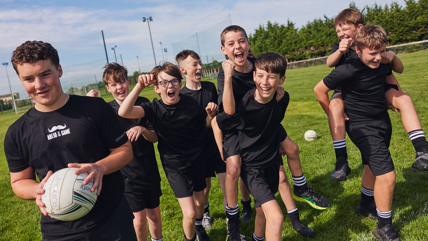 Photo of young boys on a football field.