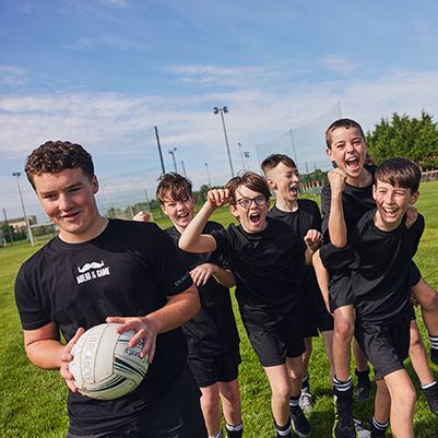 Photo of young football players on a playing field.