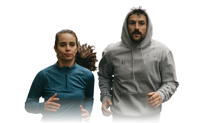 Photo of two people in running attire, jogging toward camera.