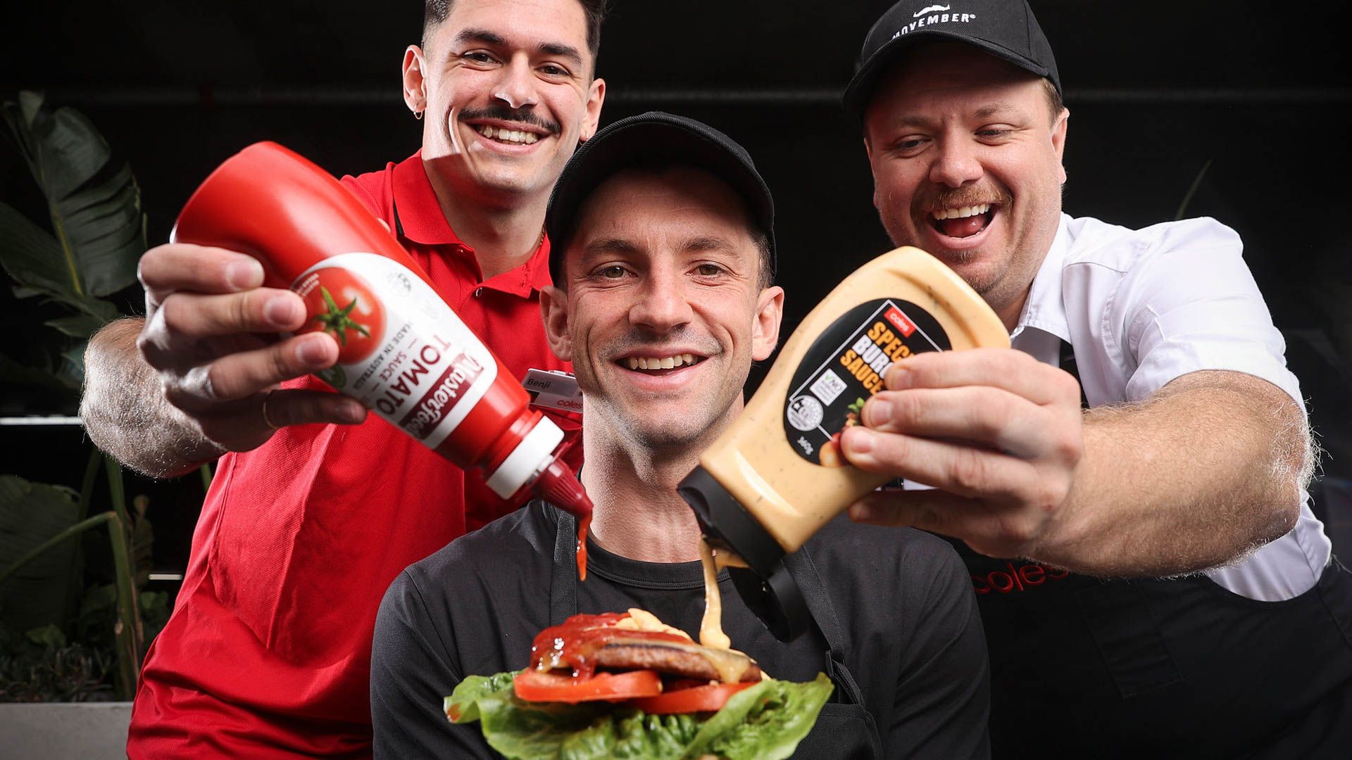 Photo of Coles employees holding Coles merch that donates to Movember.