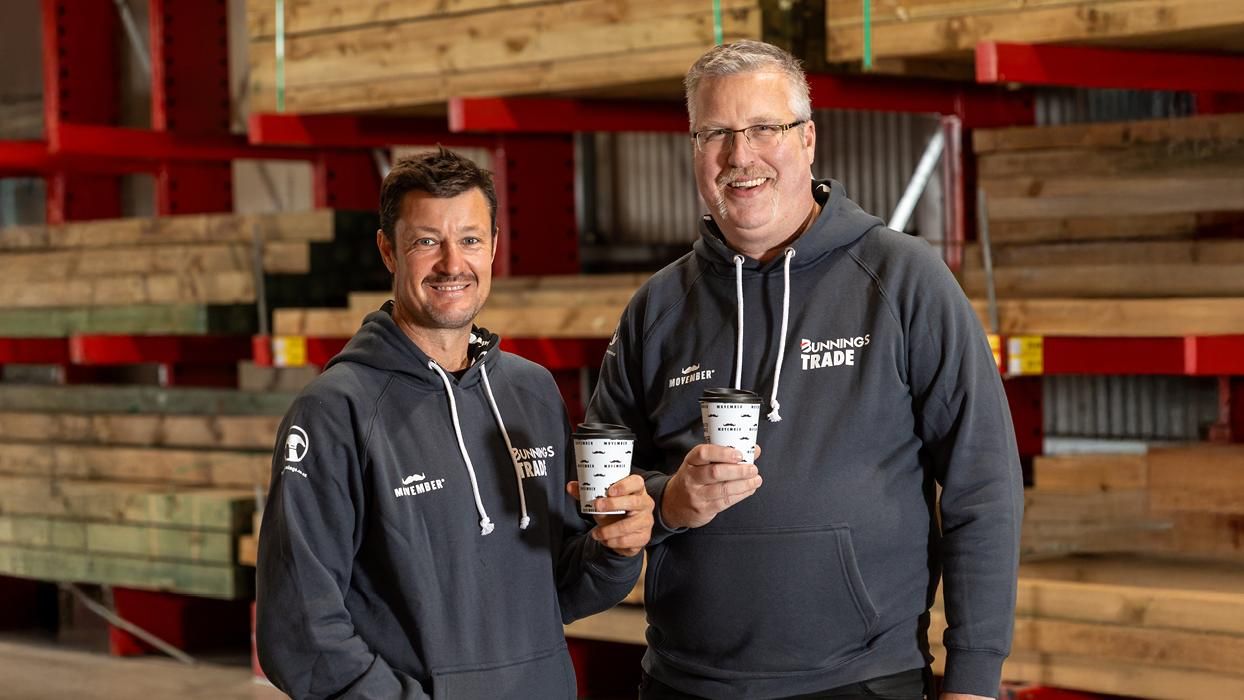 Photo of two men wearing hoodies featuring Bunnings Trade and Movember branding.