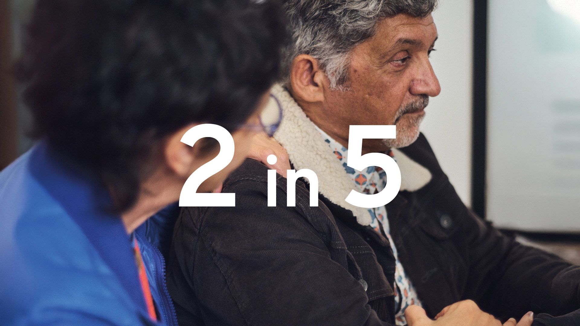 Dramatic photo of an elderly man receiving bad medical news while sitting next to his spouse. The figure "2 in 5" is superimposed in large white text.